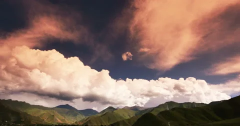 4k timelapse puffy clouds mass rolling over Tibet mountaintop &amp; valley,Sunset. Stock Footage 45365143