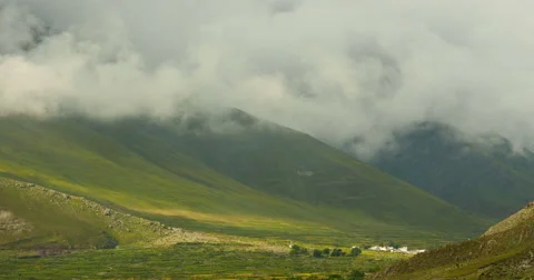 4k timelapse puffy clouds mass rolling over mountaintop &amp; valley in tibet. Stock Footage 45610428