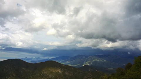 4K timelapse of rain clouds billowing over beautiful mountain landscape Stock Footage 38126087