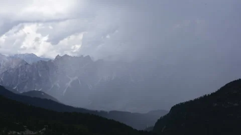 4K Timelapse of rain clouds moving in front of rugged mountain range Stock Footage 138171455