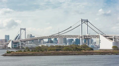 4K Timelapse of Rainbow Bridge and Tokyo skyline in background with cloudy Stock Footage 64662887