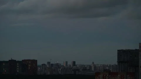4K Timelapse rainy clouds over city view before sunset, become dark Stock Footage 247429563