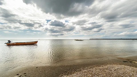 4K timelapse running of thick clouds from the camera over the sea with an orange Stock Footage 116549335