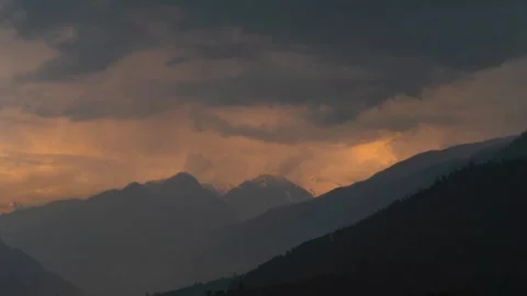 4K timelapse shot of orange clouds above the Himalayan mountain range with rain  Stock Footage 341557619