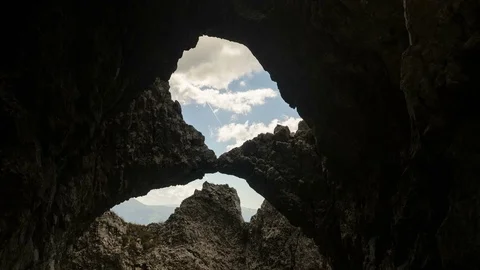 4k timelapse shot with a stone arch in Piatra Craiului Mountains, Romania. Stock Footage 77140412