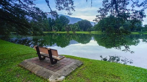 4K Timelapse of single chair infront of Lake garden. Stock Footage 115721381