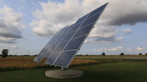 A 4K Timelapse of a solar panel in motion with blue skies 4K Video stock 115940651