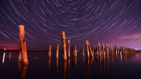 4k Timelapse star trails Night above the ocean water. Moving stars and clouds. Stock Footage 220089812