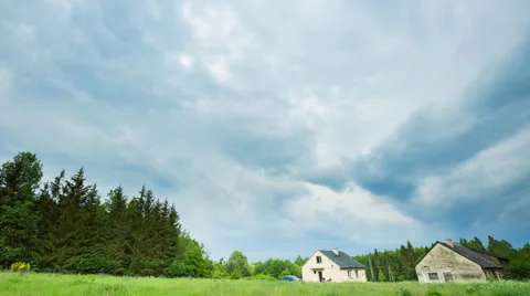 4k timelapse of storm aproaching over house in village Stock Footage 63616288