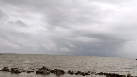 4K Timelapse Storm Clouds Moving Over Sea Coast with Coastal Breakwater Stock Footage 339214916