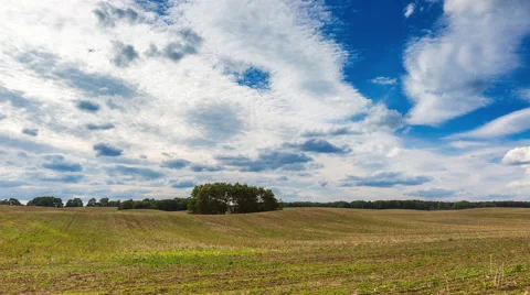 4k timelapse of stubble field under cloudy sky Stock Footage 58906992