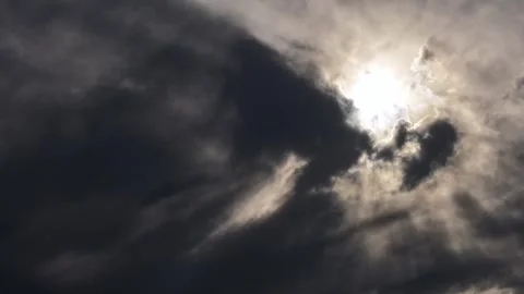 4K Timelapse: Sun Partially Hidden by Fast Moving Dark Clouds Stock Footage 339836355
