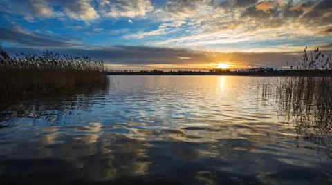 4k timelapse of sun setting over beautiful lake. Tranquil timelapse Stock Footage 60606341