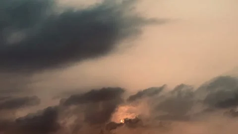 4K Timelapse of Sunlight Emerging Through Dark Atmospheric Clouds Stock Footage 341858283