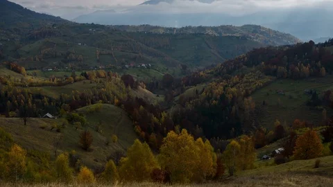 4k timelapse of sunrays beaming over colorful forests in Transylvania, Romania. Stock Footage 77677099