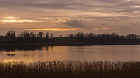 4k timelapse of sunset cloudy sky over autumnal lake Stock Footage 60039621