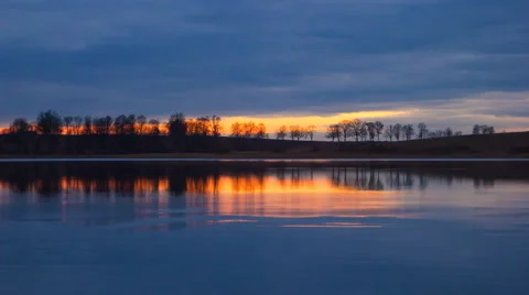 4k timelapse of sunset sky over lake waters Stock Footage 61307069