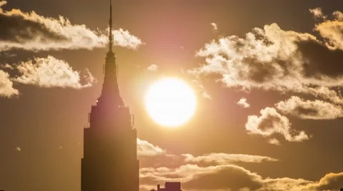 4K Timelapse sunset through clouds on empire state building Stock Footage 48723530