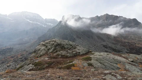 4K timelapse of top of the mountain, moving clouds on peak, autumnal foliage Stock Footage 220020702
