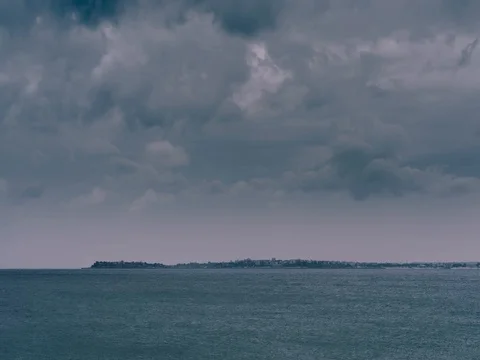 4K timelapse video of dark storm clouds above city coast. Stock Footage 80306579
