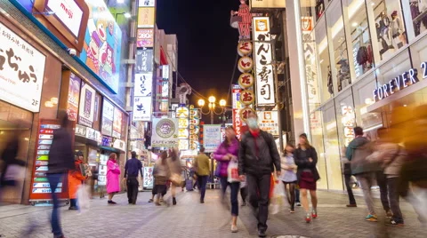 4k timelapse video of tourists visiting a shopping street at night Stock Footage 44239313
