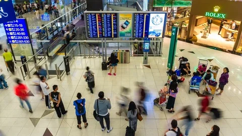 4k timelapse video of travellers around the information board in an airport Stock Footage 80853492