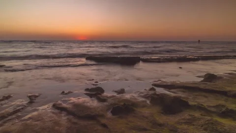 4K Timelapse view of the waves crashing on the rocks during sunset in the sea Stock Footage 312120649