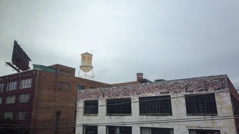 4K Timelapse of Water Tower with Passing Clouds: Stunning Urban Aerial View Vídeo Stock 256496918