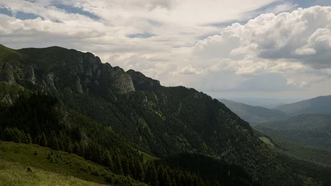 4k timelapse of white clouds running over green valley in Ciucas Mountains. Stock Footage 77140394