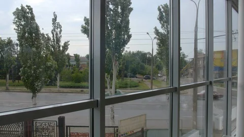 4K timeslapse view from huge window on the road and the poplar swinging in the Stock-Footage 96542069