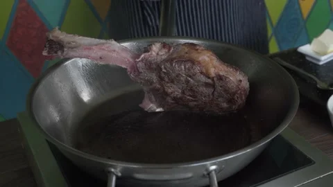 4K . Tomahawk steak is a rib eye served on a long, stripped rib. Stock Footage 146804929