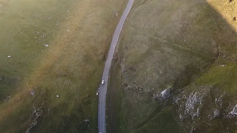 4k Top down aerial car tracking shot on beautiful country road at sunset Stock Footage 105865023