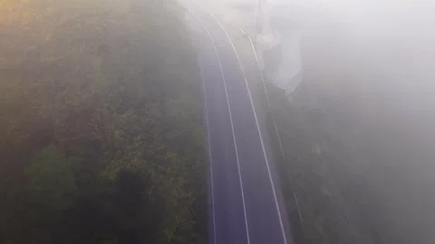 4K Top Down Drone Flight Above Foggy Road Ending in Smooth Hover 스톡 동영상 339279272