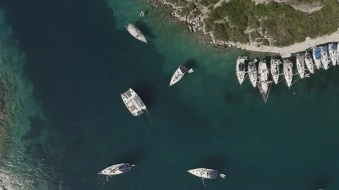 4K top down drone shot of anchored boat at Paxos port, Greece - Dlog Stock Footage 132265753