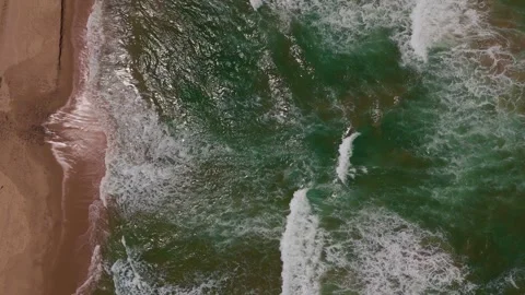 4K Top-Down Drone Shot of Ocean Waves Crashing on Sandy Shoreline Stock Footage 315401722