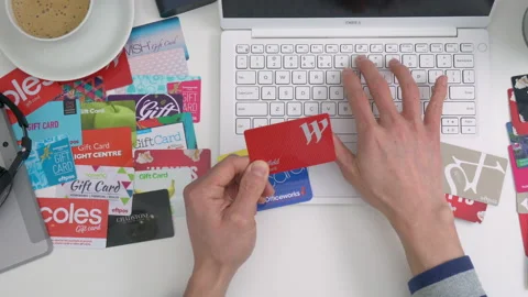 4k top down motorized dolly shot of online shopping using gift cards Stock Footage 132768891