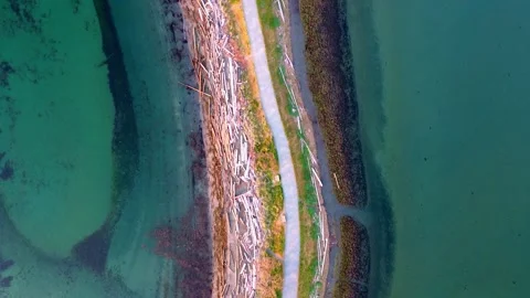 4k Top Down of Pathway with Lagoon on one side and Ocean Beach on the other Stock Footage 268681673