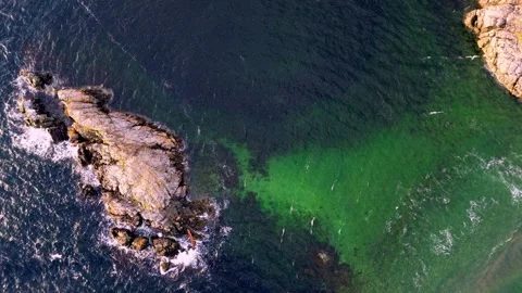 4k Top Down Rocks and Ocean Water with Sand Showing Under Video stock 268680654