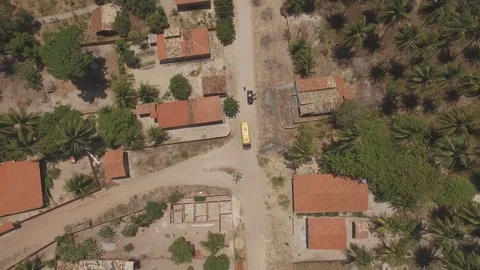 4K Top down shot of a bus driving through a small town Stock Footage 85913350