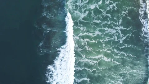 4K Top down shot camera follows waves crashing in shallow water Stock Footage 115507271