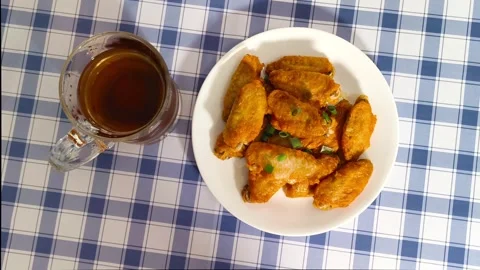 4K top down view of glass cup beverage and crispy hot fried chicken wings w.. Stock Footage 318252020