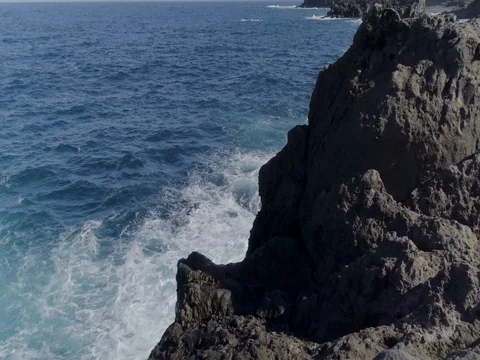 4k top drone shot of oceanic powerful waves hitting rocks Stock Footage 83871039