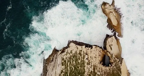4K top view of birds soaring over the rocky desert ocean island Peniche Portugal Stock Footage 119647128