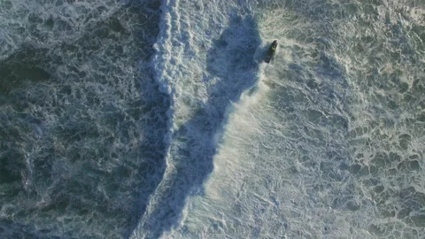 4K top view of jet ski rider making its way through rolling ocean waves Stock Footage 159842193