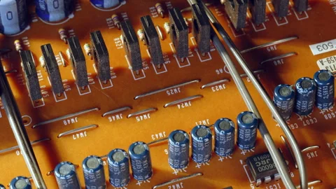 4K Top View PCB - Power Transistor &amp; Capacitor Parade - Rotating - Full Frame Stock Footage 331170815