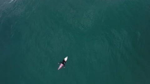 4K Top view of professional surfer swimming on surfboard in calm ocean Stock Footage 156029960