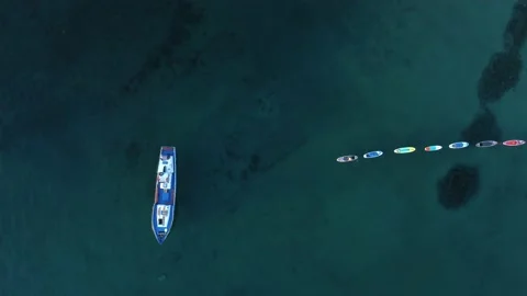 4k Top view of ship and supboards move on water in open air irrl. Stock Footage 219895178