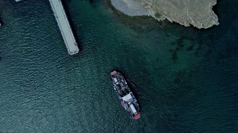 4k Top view of ship with cargo moves through water and comes to port irrl. Stock Footage 216469505