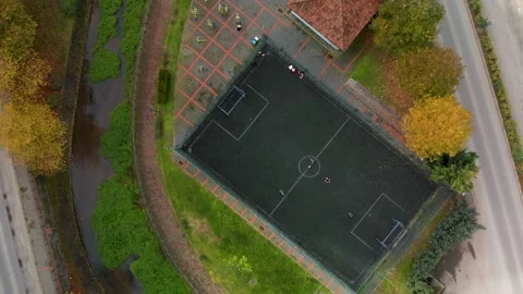 4k top view of the stadium in the Park with kids playing football Stock Footage 235786310