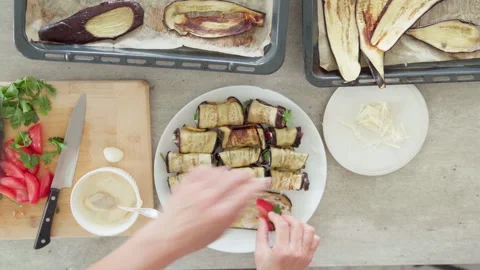 4K top view video of woman’s hands preparing delicious baked eggplant rolls stuf Video stock 329740283
